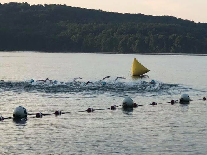 group of adults at the beginning of the race toward the first buoy