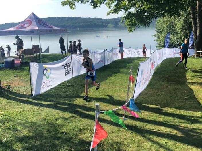 youth running up the chute from swimming to biking