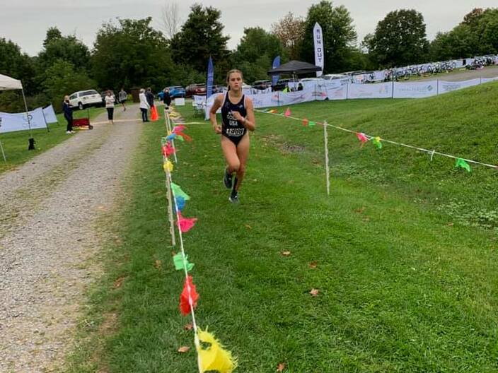 female youth running in adult race