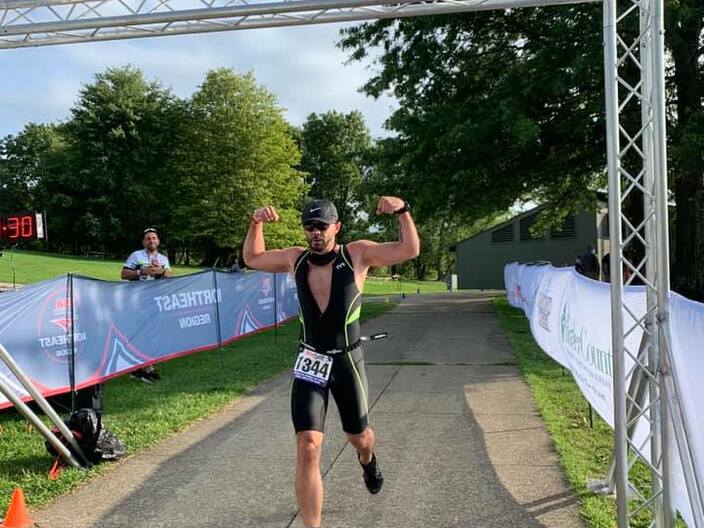 Male with strong arms at finish line