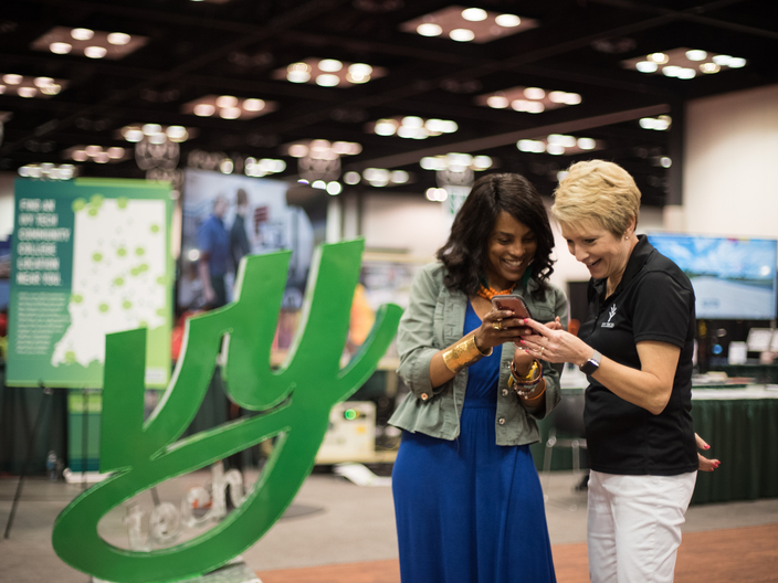 Dr. Sue Ellspermann engages with an attendee of the Indiana Black Expo, 2019